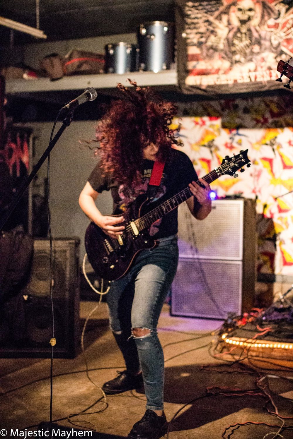 Live on stage, headbanging with a guitar